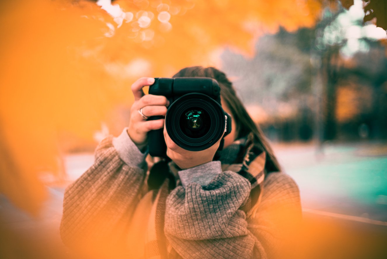 Woman Taking Photo with a Black Camera